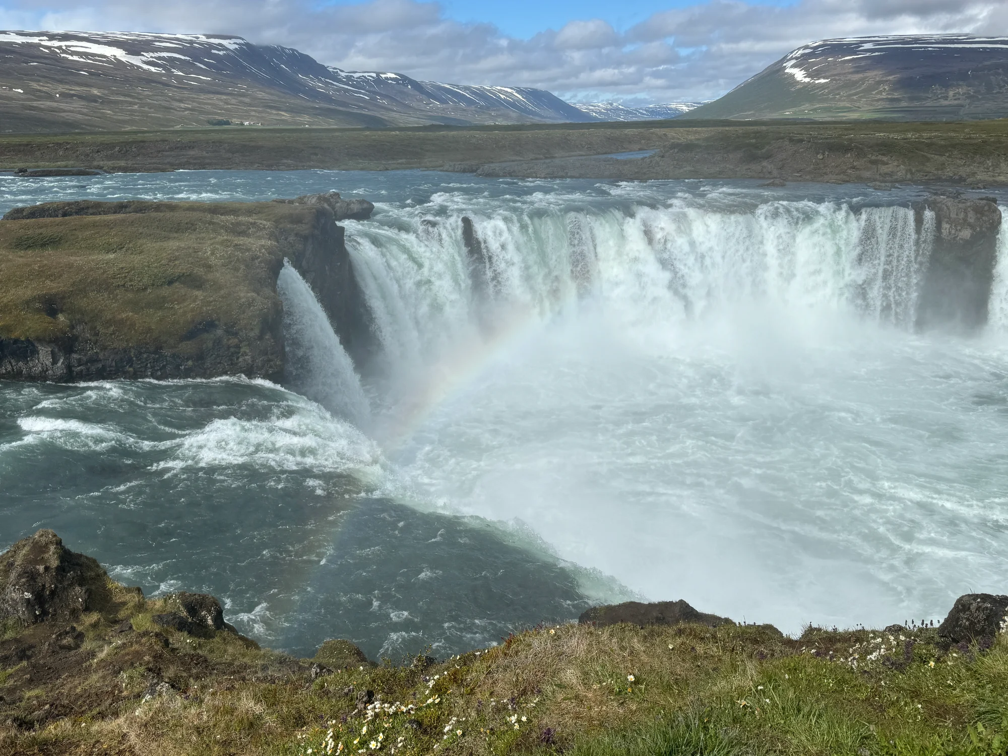 The view of Goðafoss from the east side viewing platform with a hint of a rainbow